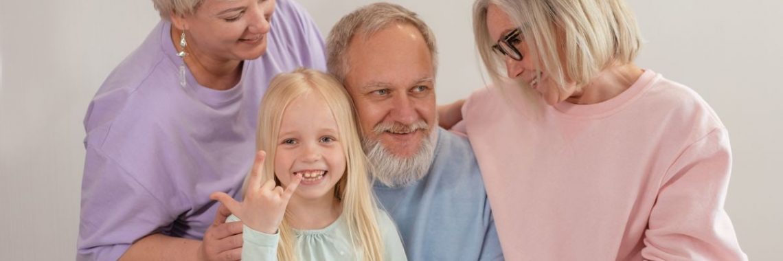 A joyful multigenerational family poses and smiles together indoors, showcasing love and togetherness.